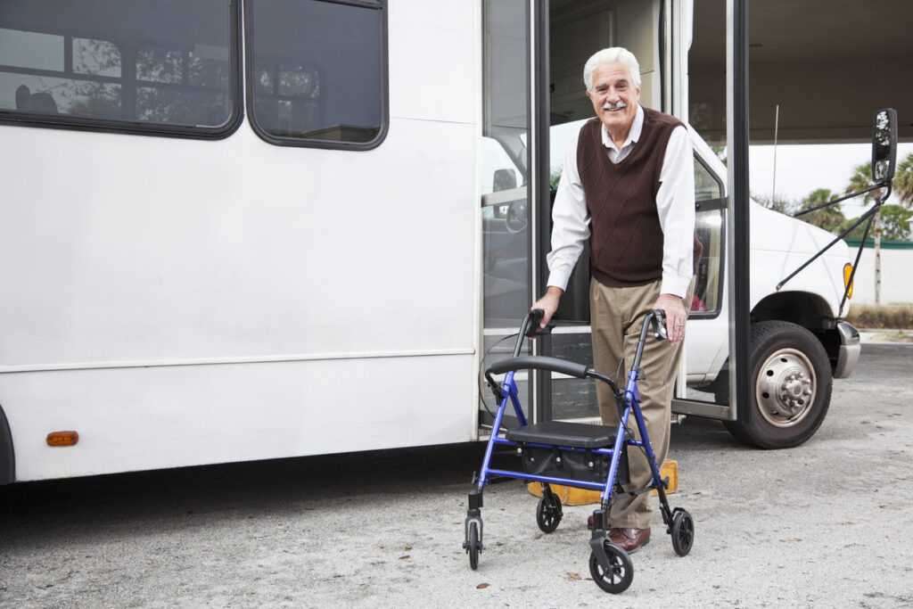 senior man with walker arrives with non-emergency medical transportation service