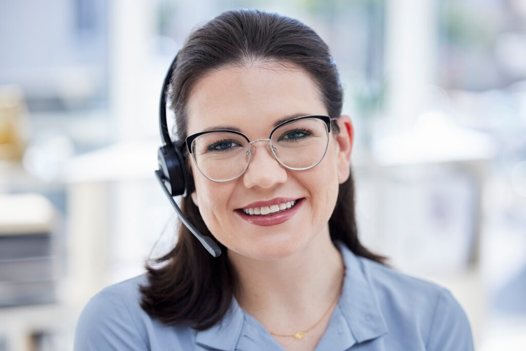 female phone agent wearing headset and eyeglasses